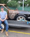 Simon Leven Owner of Leven Restorations sitting on a 1965 Mustang